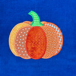 An appliqué of a pumpkin in patchwork  by snugglepuppyapplique.com
