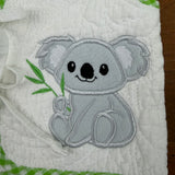 An applique of a koala baby holding eucalyptus by snugglepuppyapplique.com
