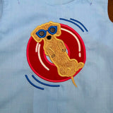an applique of a dachshund floating on an inner tube by snugglepuppyapplique.com