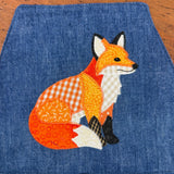 An applique of a patchwork fox by snugglepuppyapplique.com