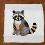 A patchwork applique of a raccoon with zigzag stitches by snugglepuppyapplique.com