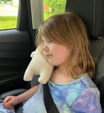 A child using an in the hoop seatbelt bear pillow by snugglepuppyapplique.com