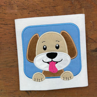a machine applique of a cartoon style dog with his paws out the window and tongue out by snugglepuppyapplique.com