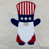 A 4th of July machine applique of a gnome wearing Uncle Sam's top hat by snugglepuppyapplique.com