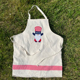 An apron with an applique of a gnome wearing uncle Sam's top hat by snugglepuppyapplique.com
