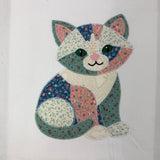 A zigzag applique of a kitten in patchwork by snugglepuppyapplique.com