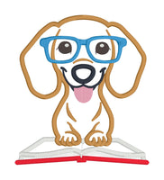 An applique of a dachshund wearing glasses and his paws on an open book by snugglepuppyapplique.com