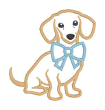 An applique design of a dachshund with a large bow around his neck