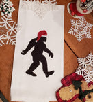 A zigzag  applique of Bigfoot Sasquatch wearing a Santa hat 
