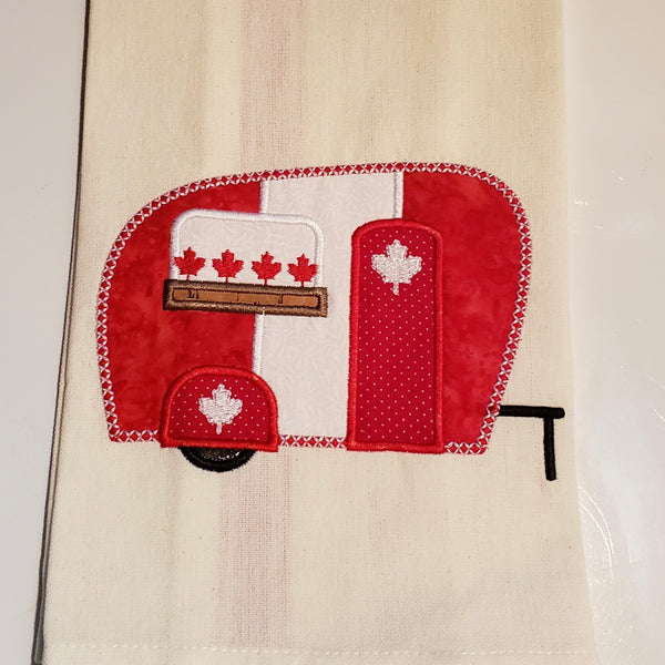An applique of a camper with maple leaves  by snugglepuppyapplique.com