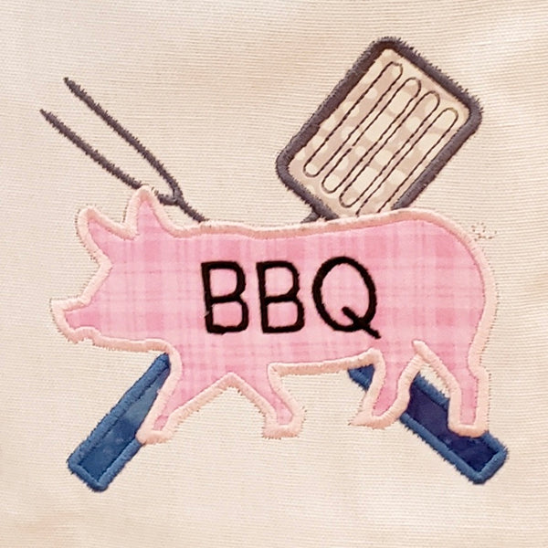 An applique of cooking utensils and a Pig with "BBQ" embroidered on it by snugglepuppyapplique.com