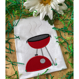 An applique of a BBQ grill with the lid on the ground and heat waves coming off the girll, grass and a dandelion  snugglepuppyapplique.com