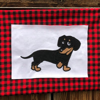 Black and tan dachshund applique design in profile, one paw is lifted and head is turned., snugglepuppyapplique.com