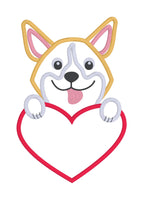 A Valentine applique to personalize of a Welsh Corgi with his paws on a heart and tongue out by snugglepuppyapplique.com