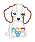 Applique of a puppy holding an Easter basket in it's mouth.  Basket has 4 Easter eggs and a bow by snugglepuppyappliqu.com