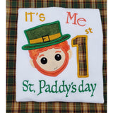 Baby's first St. Patrick'd day appliqué embroidery design,  Cute leprechaun face with a large "1"  reads "it's me 1st St. Paddy's day"
