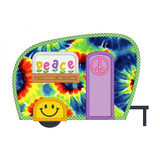 An applique of a camper with a piece sign on the door, smiley face on the fender and flowers spelling "peace" by snugglepuppyapplique.com