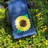 An applique design of a sunflower with two leaves by snugglepuppyapplique.com