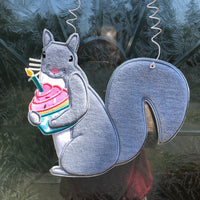 An in the hoop squirrel holding a cup cake door hanger embroidery design by www.snugglepuppyapplique.com