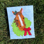 A bean stitch applique of a horse with his head through a wreath by snugglepuppyapplique.com