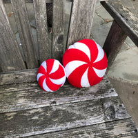 Round pillows that look like peppermint swirl Christmas candy, by snugglepuppyapplique.com
