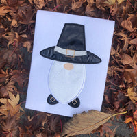 An applique of a gnome in a pilgrim hat and shoes by snugglepuppyapplique.com