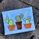 a bean stitch applique of three potted prickly pear cacti by snugglepuppyapplique.com