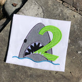 An applique of a shark biting the number two by snugglepuppyapplique.com
