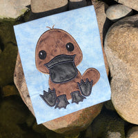 An applique of a baby platypus by snugglepuppyapplique.com