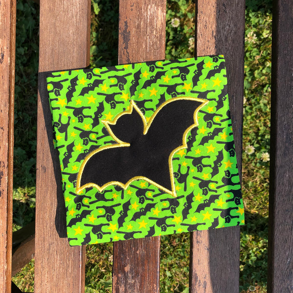 An applique of a simplistic bat embroidery design by snugglepuppyappliqe.com