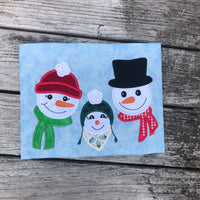 An applique of a family of snowmen by snugglepuppyapplique.com