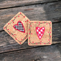 An in the hoop Valentine Coaster with a heart in the center and  a vine boarder with heart shaped flowers by snugglepuppyapplique.com