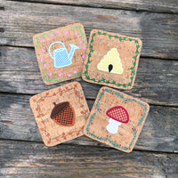 A set of 4 Coaster representing the four Seasons by snugglepuppyapplique.com
