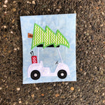 An applique of a Golf cart with a Christmas tree on top by snugglepuppyapplique.com