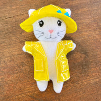 In the hoop girl kitten stuffy wearing a raincoat and hat embroidery design by snugglepuppyapplique.com