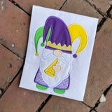 An applique of a gnome blowing a horn and wearing a jesters hat  Mardi gras applique by snugglepuppyapplique.com