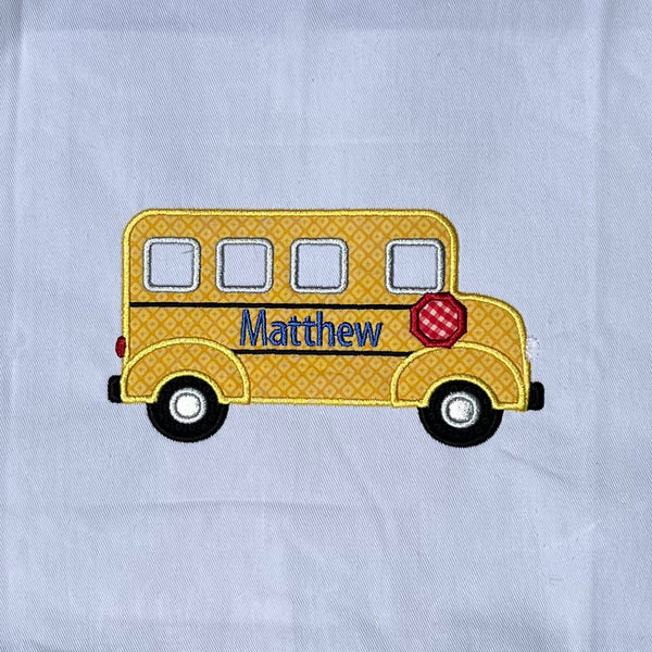 An applique of a school bus in profile with space to personalize by snugglepuppyapplique.com