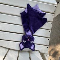 An in the hoop embroidery design of a stuffed bat head attached to a small blanket by snugglepuppyapplique.com