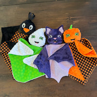 In the hoop Lovey Bundle of 4 design, Crow, Ghost, Bat and Pumpkin attached to a small blanket by snugglepuppyapplique.com