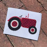 An applique of an old fashioned farm tractor by snugglepuppyapplique.com