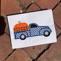 An applique of a old pick up truck with a giant pumpkin in the  truck bed by snugglepuppyapplique.com