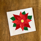 An applique of a Christmas poinsettia with a zig zag stitch by snugglepuppyapplique.com