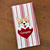 A Valentine  applique of a Welsh Corgi with his paws on a heart and tongue out by snugglepuppyapplique.com