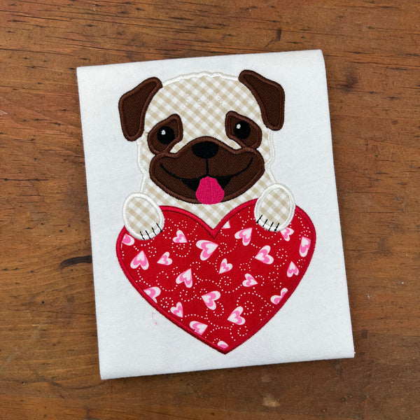 An applique of a pug with his paws on a heart by snugglepuppyapplique.com