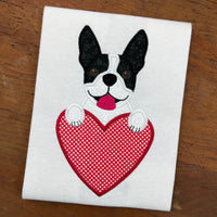 A valentine Applique of a Boston Terrier Dog with its paws on a heart by snugglepuppyapplique.com