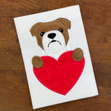 A Valentine applique of a bulldog with its paws on a heart  by snugglepuppyapplique.com