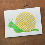 An applique of a garden snail smiling by snugglepuppyapplique.com