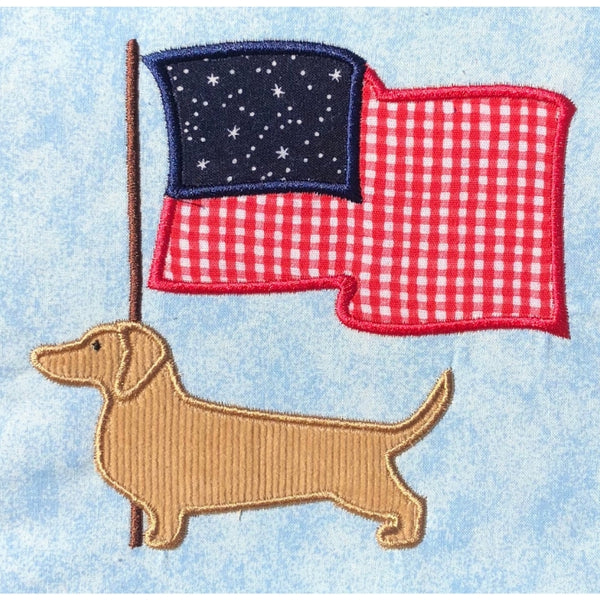 July Dachshund applique embroidery design, Dachshund in profile with American or Canadian Flag behind him fluttering in the breeze