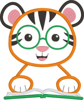 An applique of a Tiger with his paws on a book and wearing embroidered glasses by snugglepuppyapplique.com