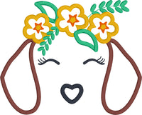 An applique of a dachshund's ears, nose and closed eyes with lashes and wearing a crown of flowers and leaves by snugglepuppyapplique.com